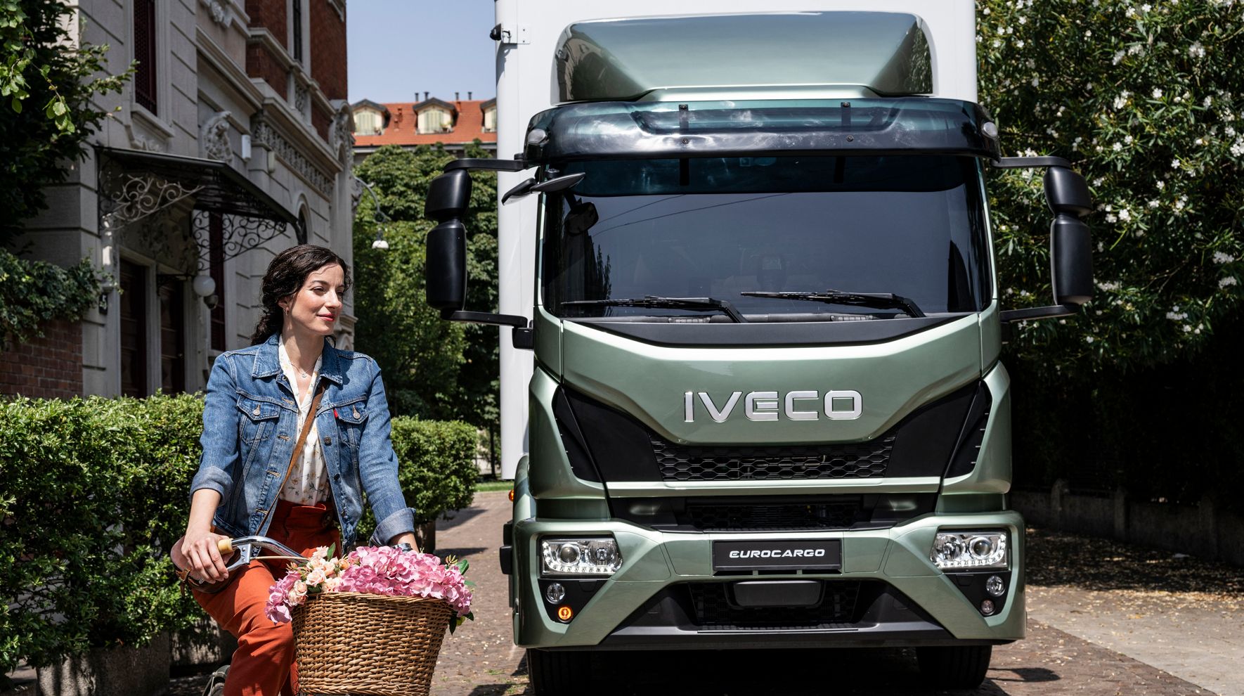 Woman on Bicycle, IVECO Eurocargo in background.